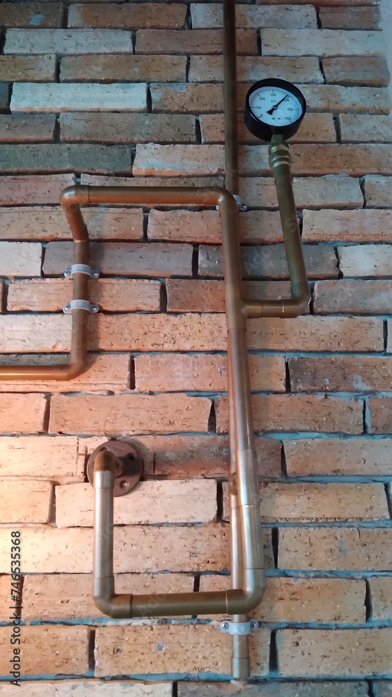 brick wall decorated with copper pipe structure with meter brick wall decorated with copper pipe structure with meter