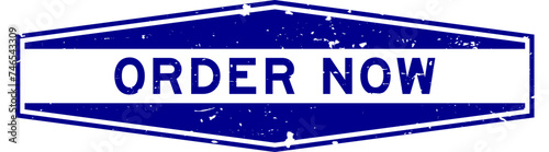 Grunge blue order now word hexagon rubber seal stamp on white background