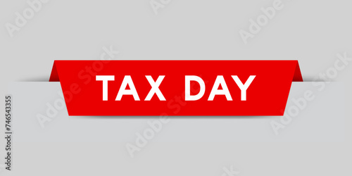 Red color inserted label with word tax day on gray background