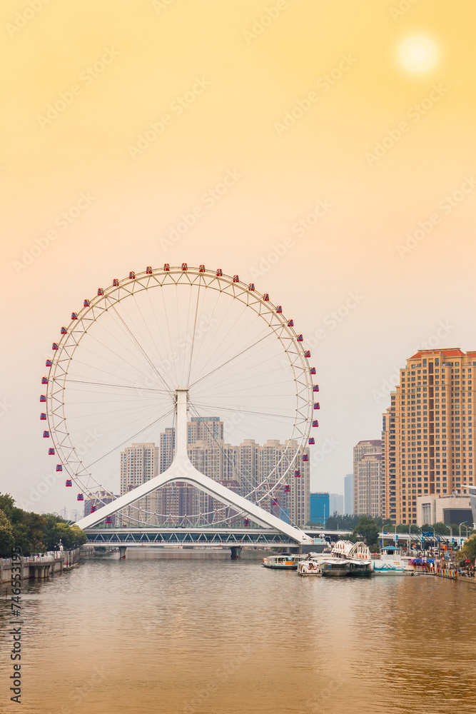 Sunset over the Tianjin Eye ferris wheel in Tianjin, China