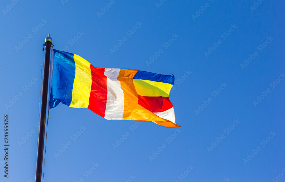 Buddhist flag against a blue sky in Dabei Monastery in Tianjin, China Buddhist flag against a blue sky in Dabei Monastery in Tianjin, China