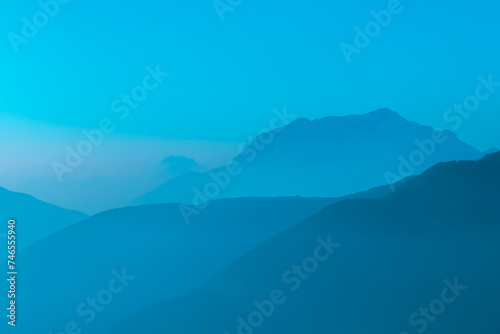 Spectacular mountain ranges silhouettes in shades of light blue. © Daniele