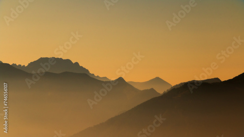 Spectacular mountain ranges silhouettes in shades of yellow.
