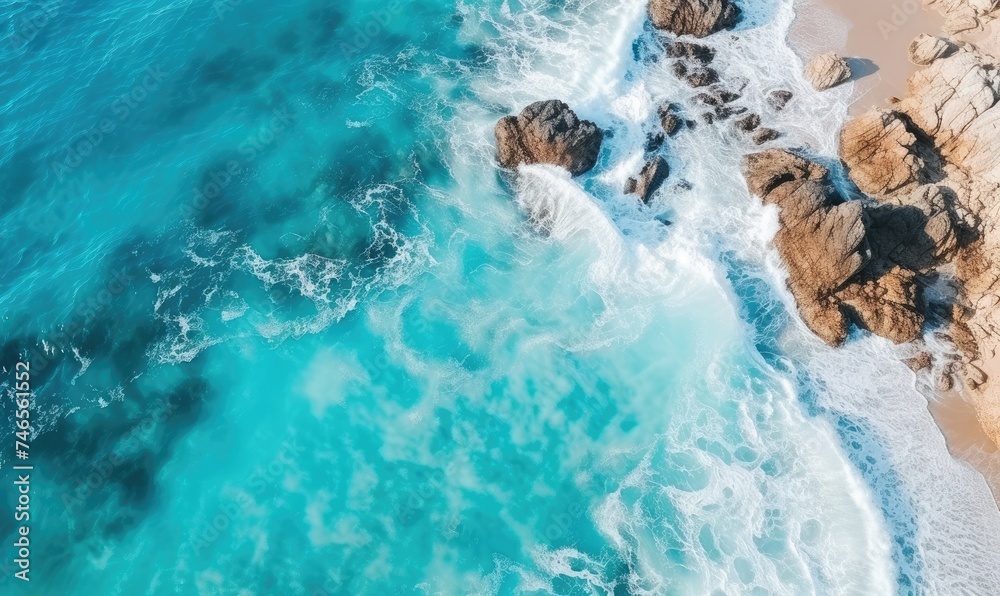 A Majestic Aerial Perspective of the Vast Ocean and Weathered Rocks