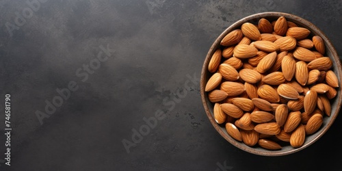 Organic almonds in a ceramic bowl on a concrete floor