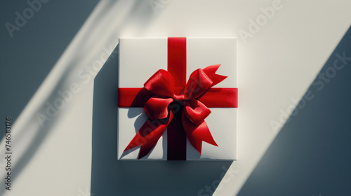Blank white gift box with red ribbon bow, isolated.