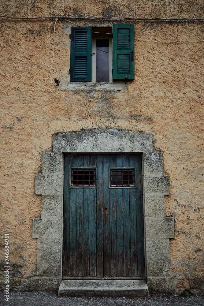 a blue old door and window in mediterranean style on stone wall