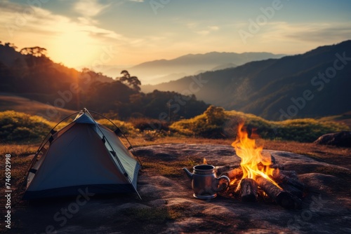 campfire and teapot Tents and mountains in the background at sunset On a traveler s holiday