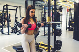 Bodybuilder goal, dumbbell focus and woman in gym for training, sports and exercise wellness. Thinking, sport strong and athlete with weights for fitness and health workout performance for muscle