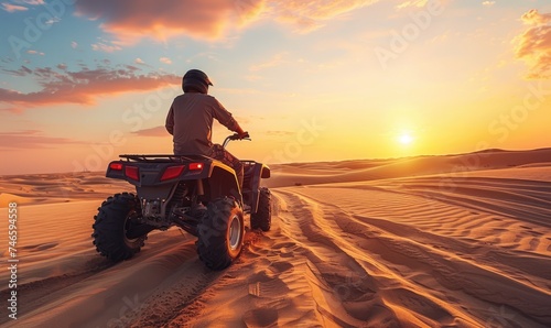 An off road ATV driving dune bashing in breathtaking view desert area at sunset or sunrise photo
