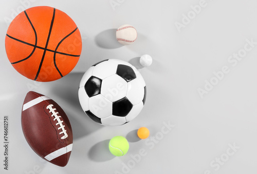 Many different sports balls on gray background, flat lay. Space for text