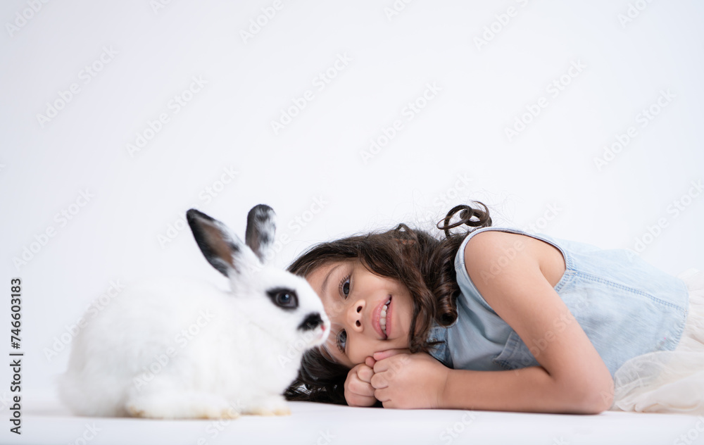 A little girl kisses her beloved fluffy rabbit, The beauty of friendship between humans and animals A little girl kisses her beloved fluffy rabbit, The beauty of friendship between humans and animals