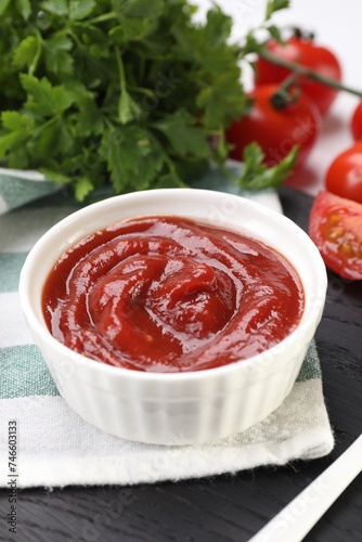 Organic ketchup in bowl on table, closeup. Tomato sauce