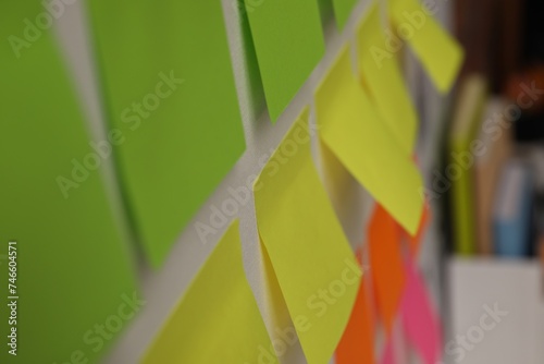 Blank colorful paper notes on white board, closeup