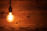 Old Vintage Light Bulb Against Grunge Wooden Wall Background - 4K Ultra HD Image