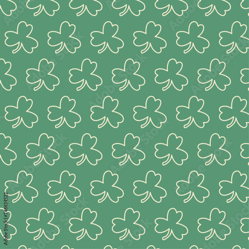 Seamless patttern with white outline clovers on green background for wrapping, st Patrick's day, packaging, wallpapers, notebooks, fabrics photo