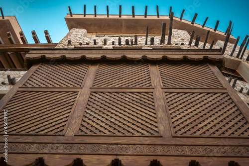 Doha, Qatar - February 8, 2024: A decorated wooden mashrabiya inside an old heritage building during the day inside Souq Waqif inside Doha, Qatar photo