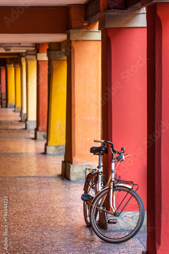 colorful portico with a bike in Bologna