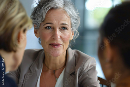 Leadership in Action: Mature Business Woman Leading Team Meeting. Generative AI.