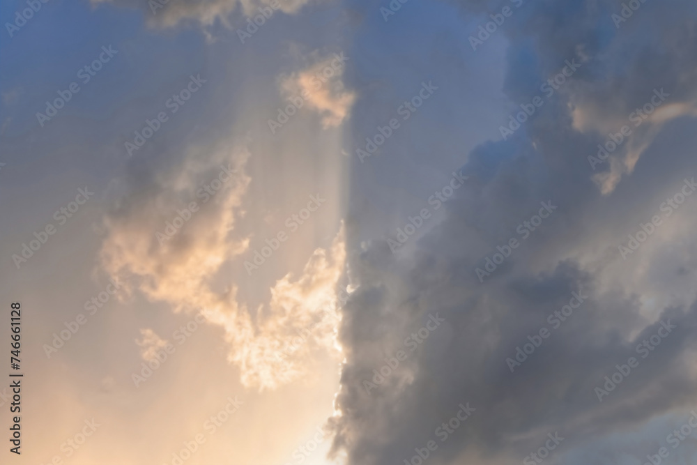 Cloudy sky divided into light and dark parts, illuminated by sunlight Cloudy sky divided into light and dark parts, illuminated by sunlight