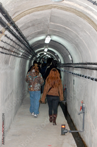person walking down the stairs of a tunnel