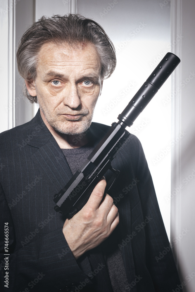 Old member of criminal gang in alert ready to shoot in hotel room Old member of criminal gang in alert ready to shoot in hotel room