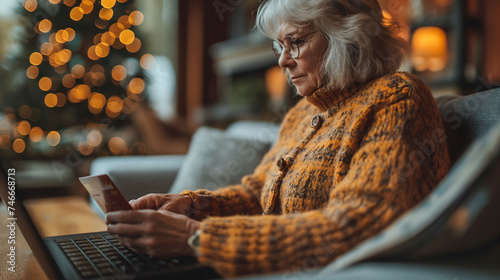 The danger of scammers tricking elderly people into filling out credit cards, Elderly people shopping online, Elderly person holding a credit card. photo