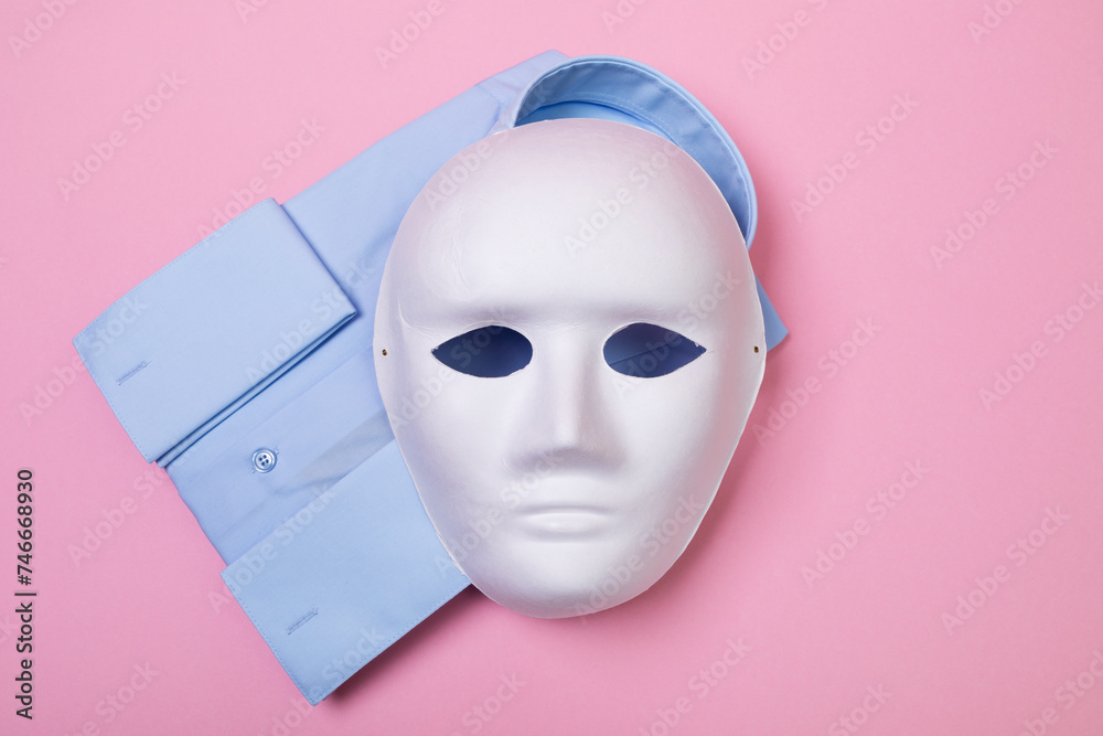 Top view of white mask and shirt on pink background, concept on counterfeit and fake products