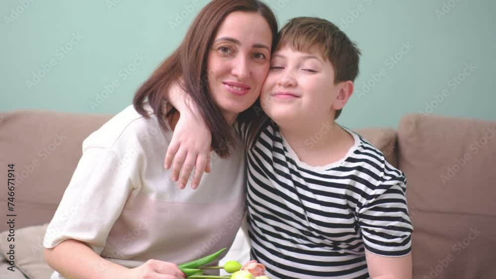 Happy little boy hugging his mother at home. Loving mum and kid cuddling embrace cheerful to family holiday event.Concept love mom. Happy little boy hugging his mother at home. Loving mum and kid cuddling embrace cheerful to family holiday event.Concept love mom.
