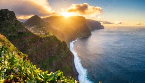 madeira island dramatic sunrise over atlantic ocean with waterfall landscape from miradouro do veu da noiva