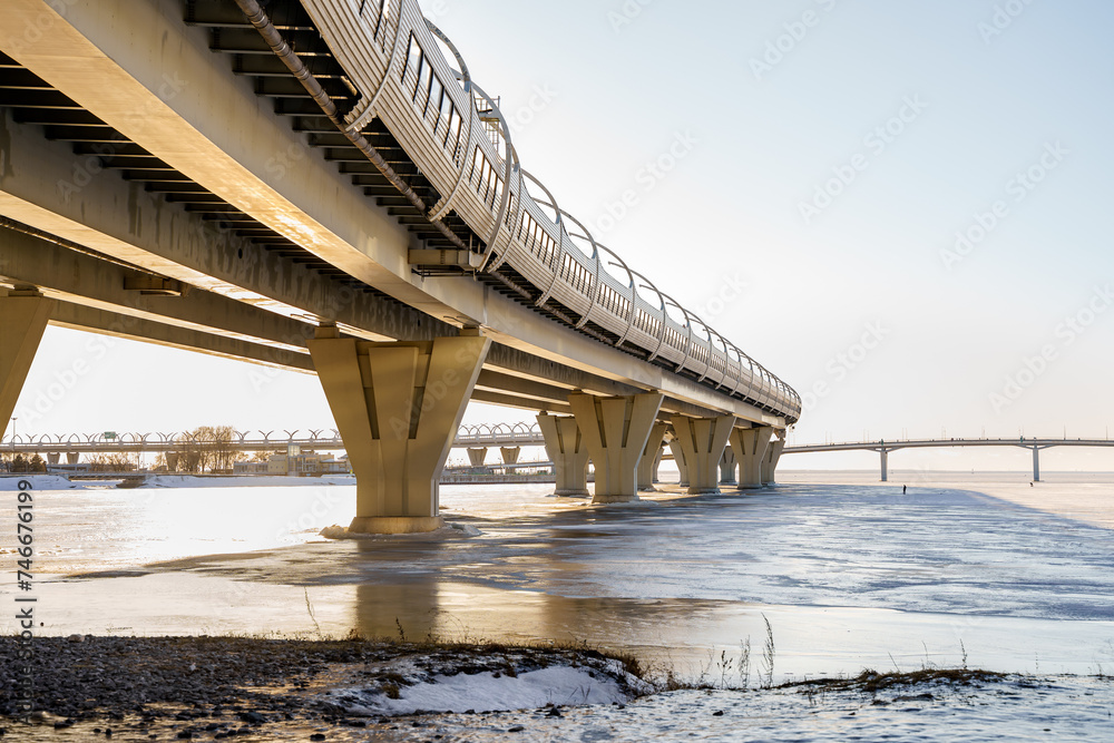 View from under the Western high-speed Diameter highway connecting the Northern part of St. Petersburg and Krestovsky Island, panorama in winter with ice on the river View from under the Western high-speed Diameter highway connecting the Northern part of St. Petersburg and Krestovsky Island, panorama in winter with ice on the river
