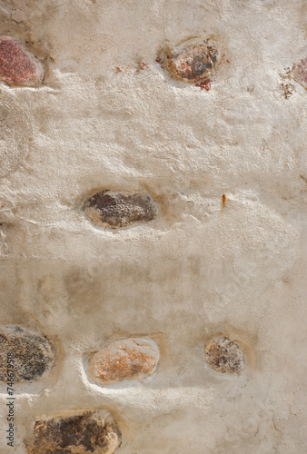 Vertical photo of an antique stone wall.