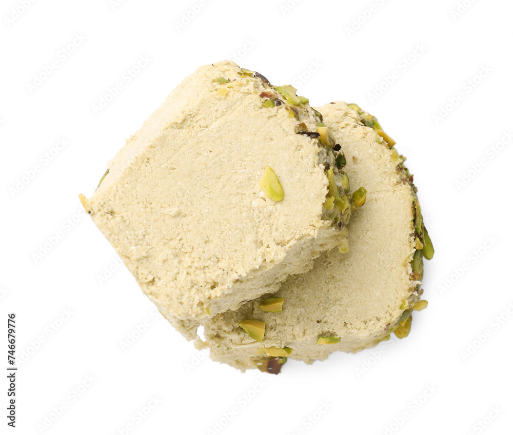 Pieces of tasty halva with pistachios on white background, top view