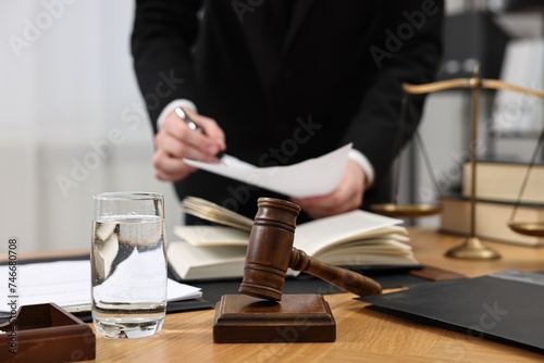 Lawyer working with document at wooden table, closeup