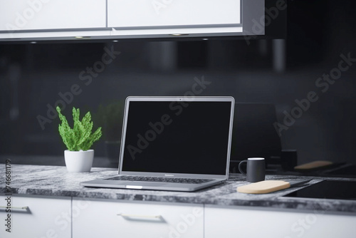 Blurred view of laptop with blank screen on white table in modern kitchen. Mock up