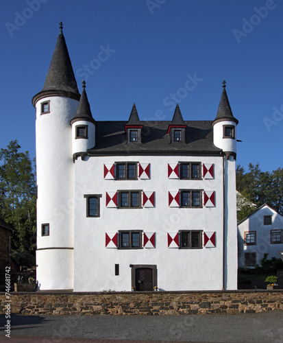 Dreis castle with medieval tower and Renaissance windows with shutters, Eifel region in Germany