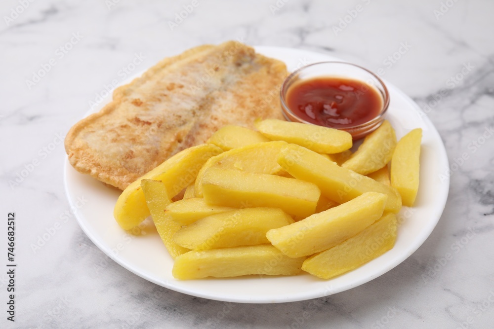 Delicious fish and chips with ketchup on light marble table, closeup Delicious fish and chips with ketchup on light marble table, closeup
