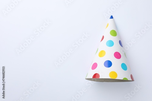 One beautiful party hat on light background, top view. Space for text