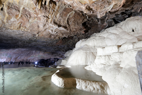 The scenic views of Kaklık cave which is full of dripstones, stalactites and stalagmites. There are also travertine formations and a small thermal lake at the bottom of the cave in Denizli, Turkey photo