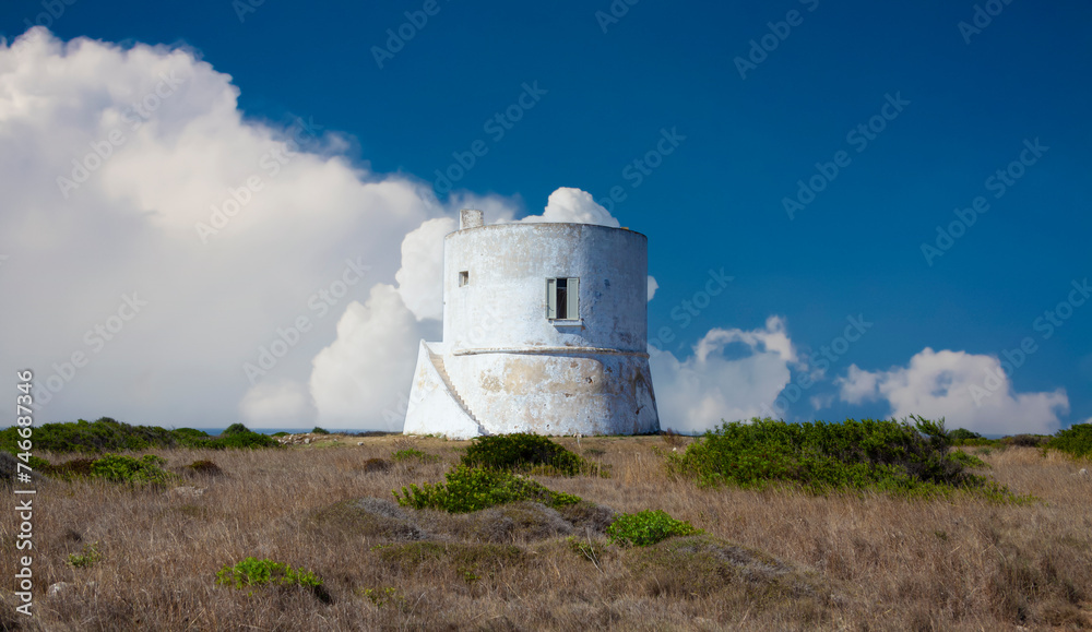 A cylindrical white tower with a flat roof and a small window. Located in Salento, Italy, built in 1569. A cylindrical white tower with a flat roof and a small window. Located in Salento, Italy, built in 1569.