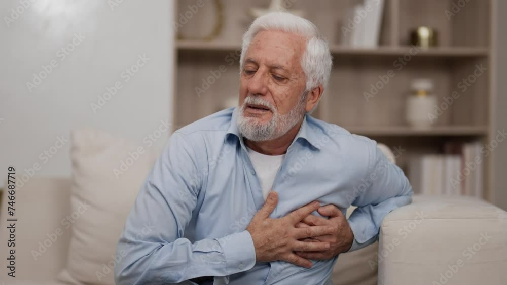 Senior man suffers from heartache. Man has heart attack, seizure sitting on couch at home. Unwell old male chest pain myocardial infarction, chronic cardiology disease. Healthcare, ill concept. Senior man suffers from heartache. Man has heart attack, seizure sitting on couch at home. Unwell old male chest pain myocardial infarction, chronic cardiology disease. Healthcare, ill concept.