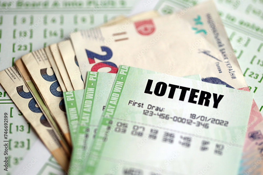 Green lottery tickets and ukrainian money bills on blank with numbers for playing lottery close up Green lottery tickets and ukrainian money bills on blank with numbers for playing lottery close up