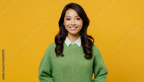 confident calm brunette latin woman wearing casual cozy green knitted sweater hold hands in pockets looking camera  photo