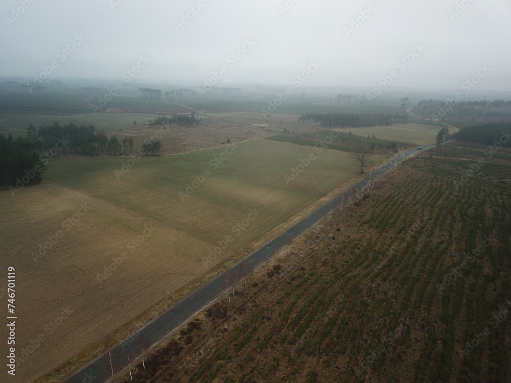 Asphalt road between fields in bad weather Asphalt road between fields in bad weather