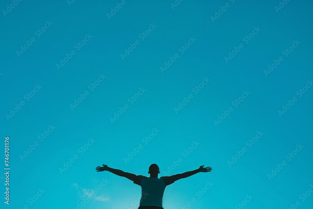 An undisturbed silhouette forms a stark contrast against the captivating blue sky at sunset, conveying peace An undisturbed silhouette forms a stark contrast against the captivating blue sky at sunset, conveying peace