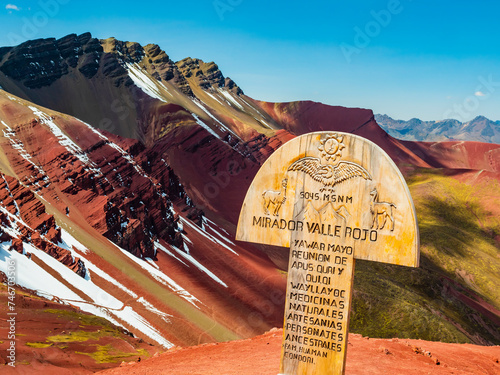 Panoramic viewpoint of the Red Valley (valle rojo) with wooden sign in foreground, Cusco region, Peru