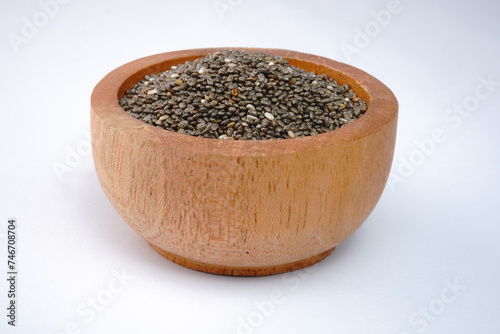 Chia seeds on a wooden bowl concept background