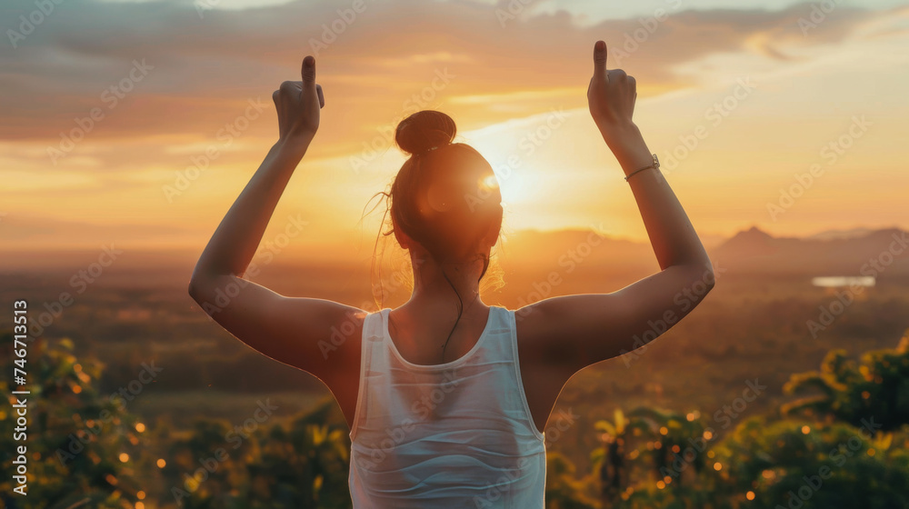 a person from behind, raising their arms with thumbs up towards the sky as the sun sets or rises, embodying a sense of accomplishment and positivity. a person from behind, raising their arms with thumbs up towards the sky as the sun sets or rises, embodying a sense of accomplishment and positivity.