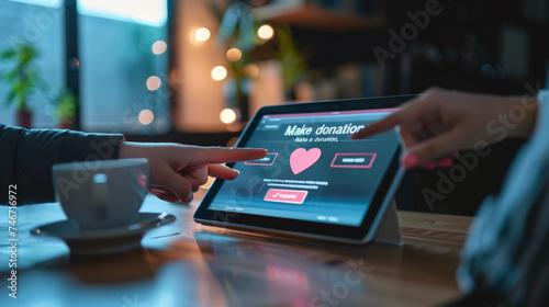 Two hands are holding a tablet displaying a 'Make a donation' screen with a heart symbol, suggesting an online charitable contribution.