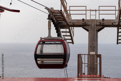 Empty cable car going to the beach of Garajau, Canico, Madeira island, Portugal, Europe. Panoramic view of majestic Atlantic Ocean with dramatic sky. Tourism. Travel destination. Tranquil scene photo
